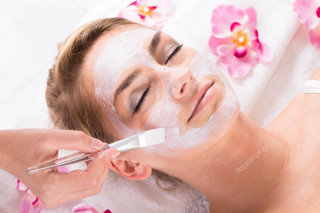 applying Mask On Customer's Face At Salon