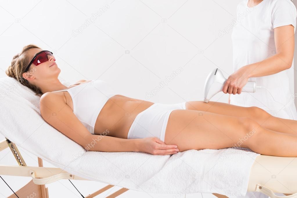 Woman Receiving Laser Treatment On Leg