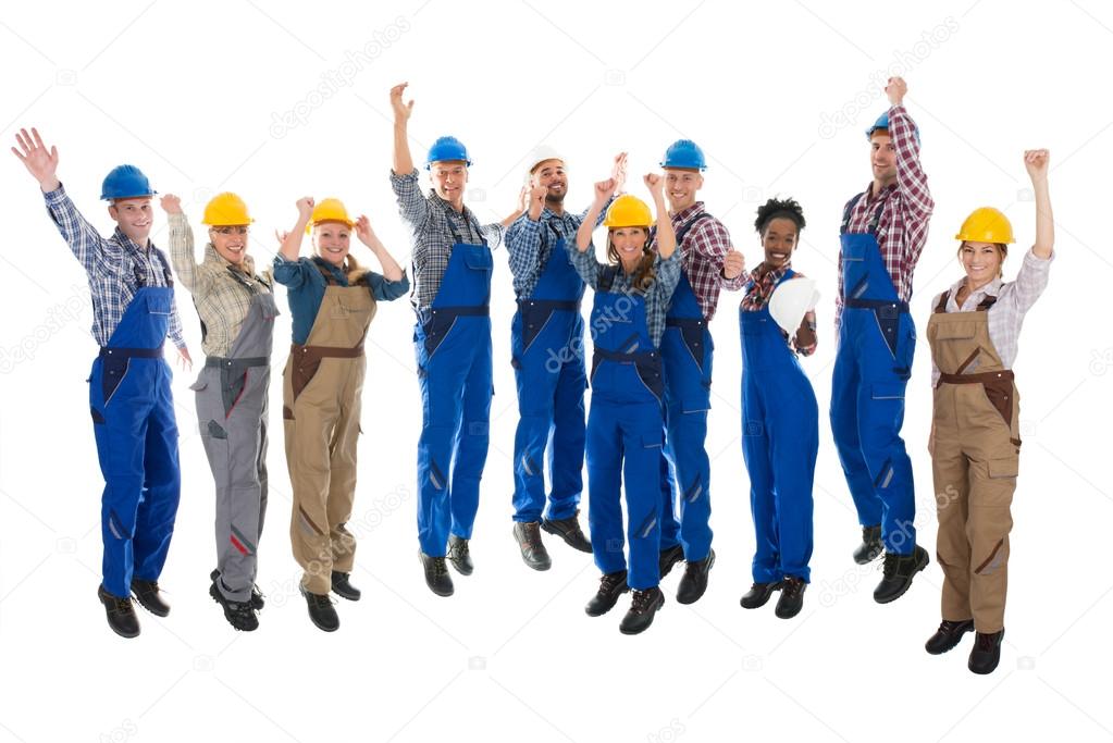 Happy Carpenters Standing With Arms Raised
