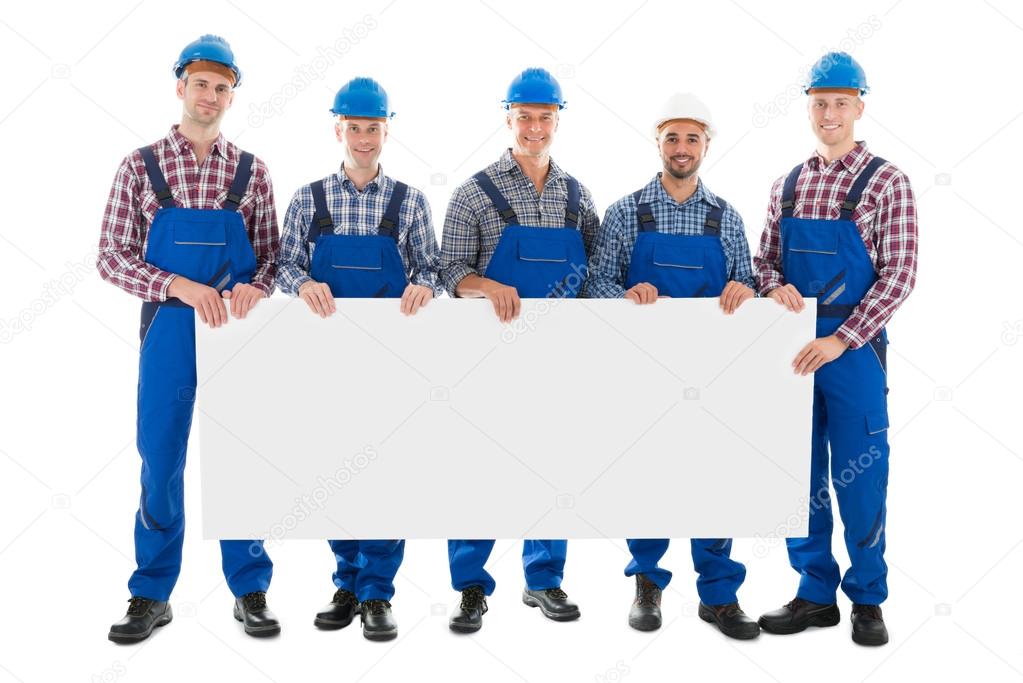 Confident Male Construction Worker Holding Blank Billboard
