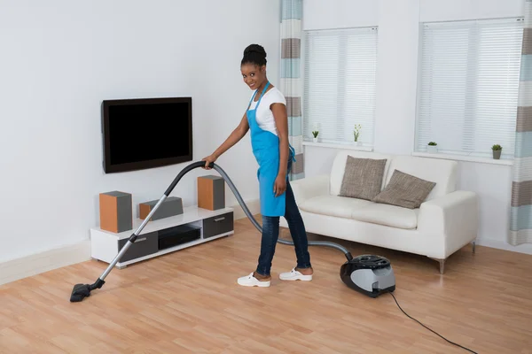 Woman Cleaning Floor With Vacuum Cleaner — Stock Photo, Image