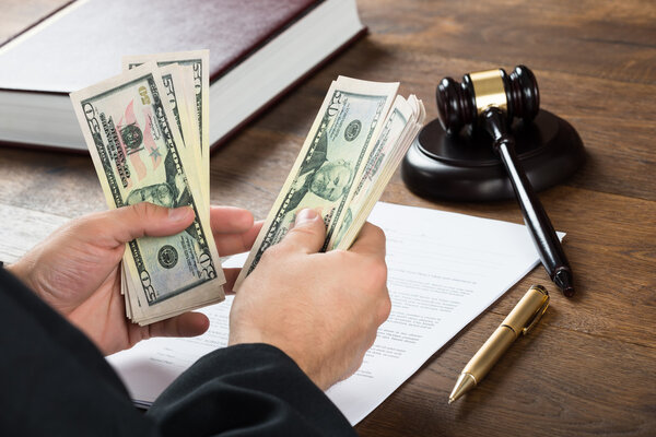 Corrupt Judge Counting Money At Desk