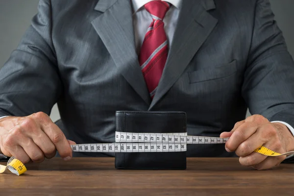 Businessman Wrapping Wallet With Measuring Tape — Stock Photo, Image