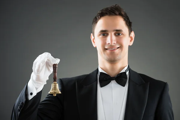 Smiling Waiter Holding Ring Bell — Stock Photo, Image