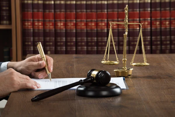 Judge Writing On Legal Documents At Desk — Stock Photo, Image