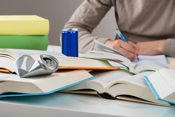 Student With Crashed Drink Can And Books — Stockfoto