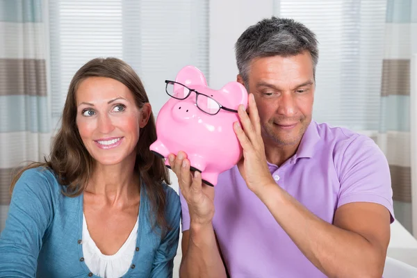 Listening Sound Of Coins In Piggybank — Stock Photo, Image