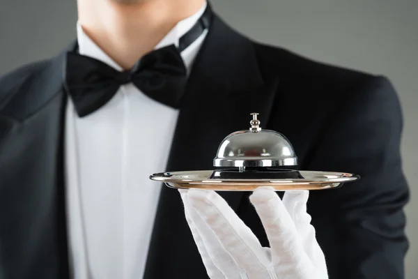 Waiter Holding Service Bell In Plate — Stock Photo, Image