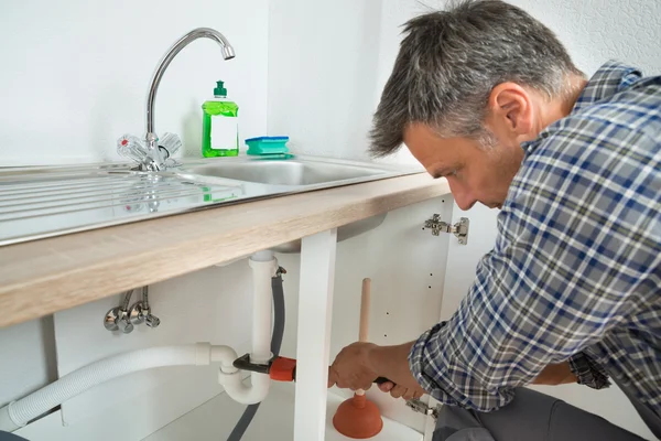 Plumber Fixing Sink Pipe In Kitchen — Stock Photo, Image