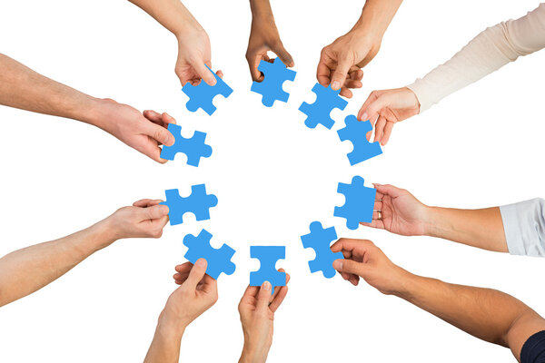 People Holding Blue Jigsaw Pieces