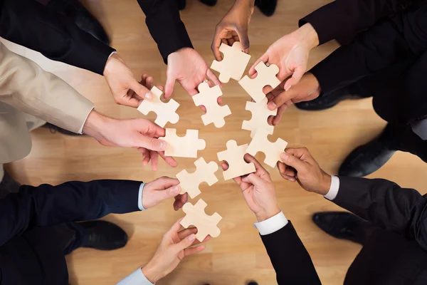 Business Team Joining Jigsaw Pieces — Stock Photo, Image