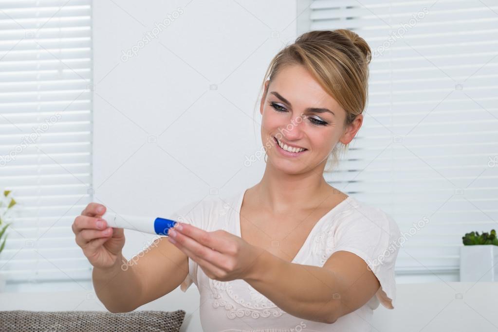 Woman Looking At Pregnancy Result At Home