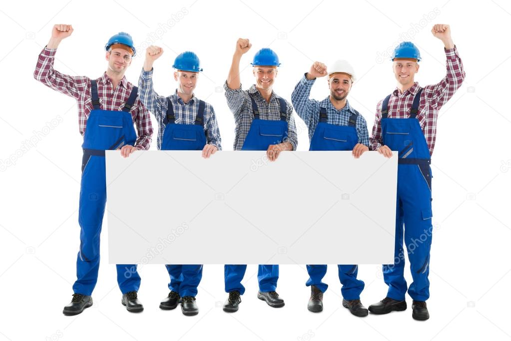 Male Carpenters With Arms Raised