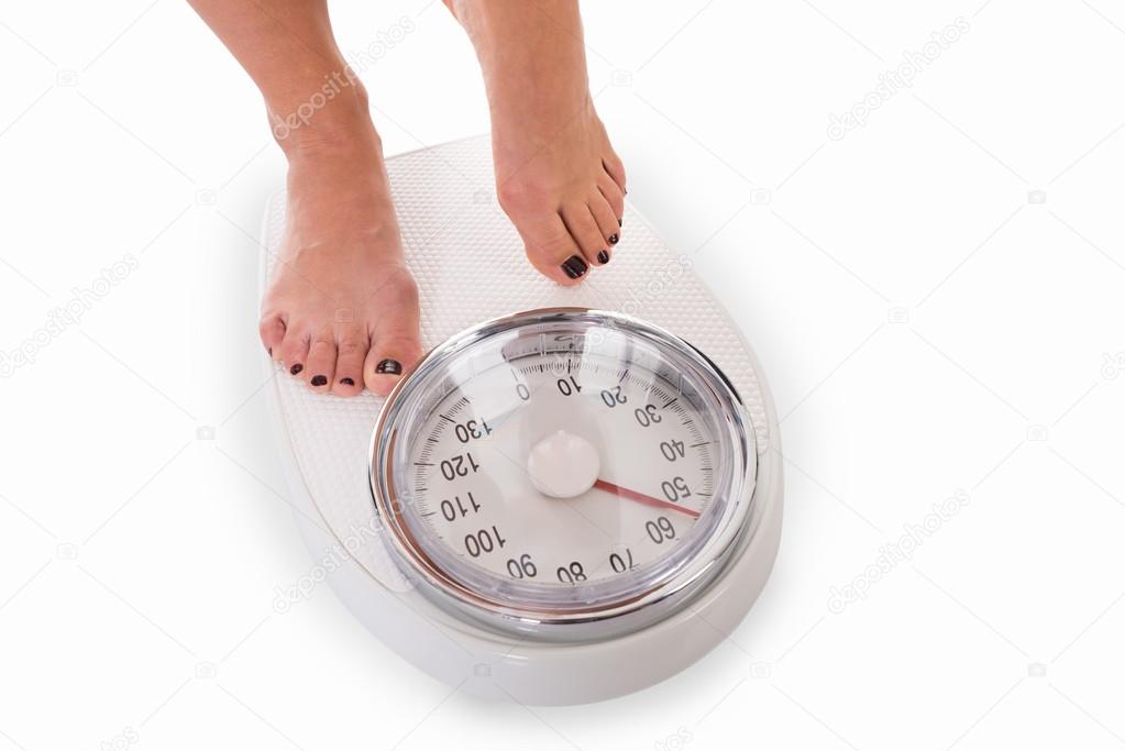 Woman Standing On Weighing Scale