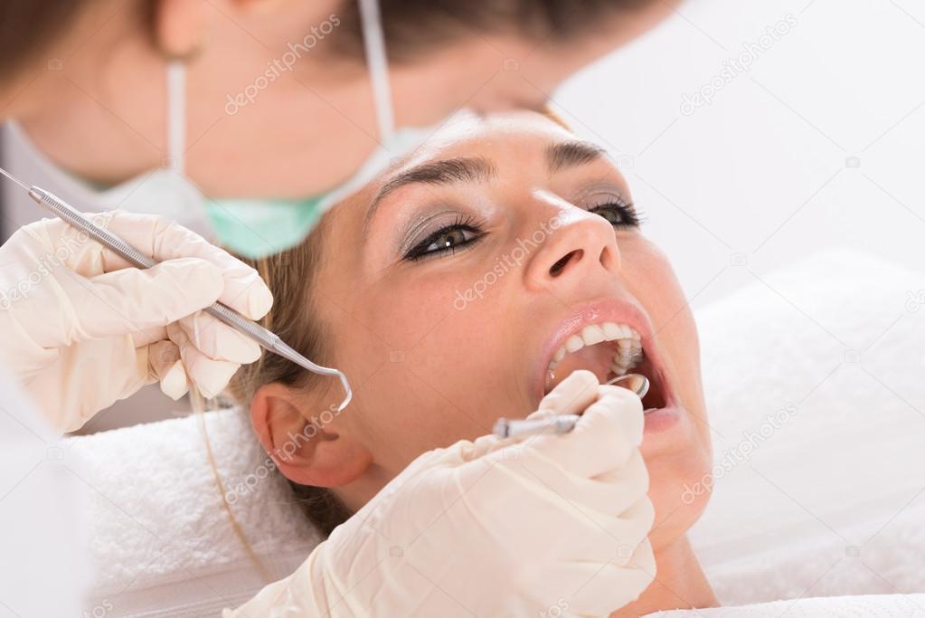 Patient Getting Dental Checkup At Clinic