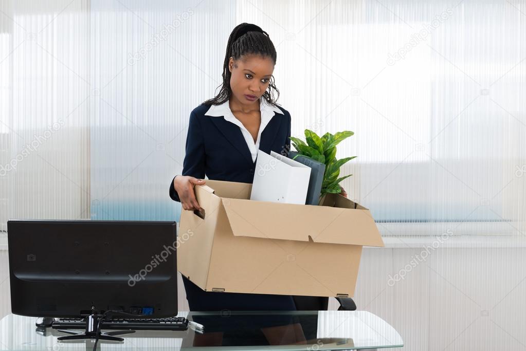 Businesswoman Carrying Box With Her Belongings