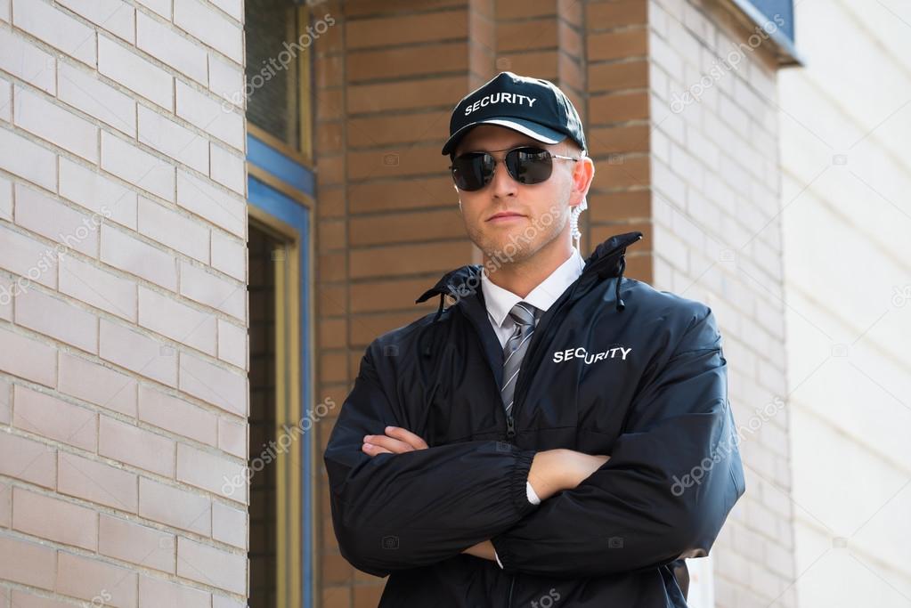 Security Guard Standing With Arm Crossed