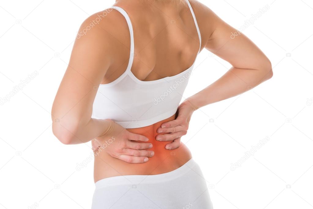 Young woman suffering from flank pain on white background Stock Photo