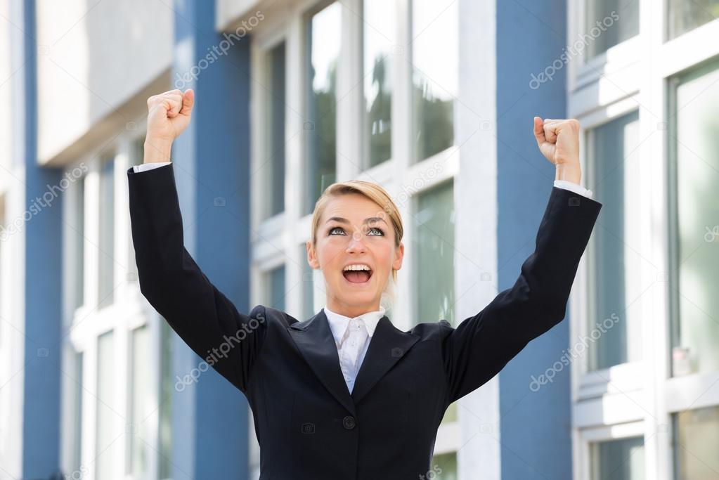 Businesswoman Raising Arms To Celebrate Success