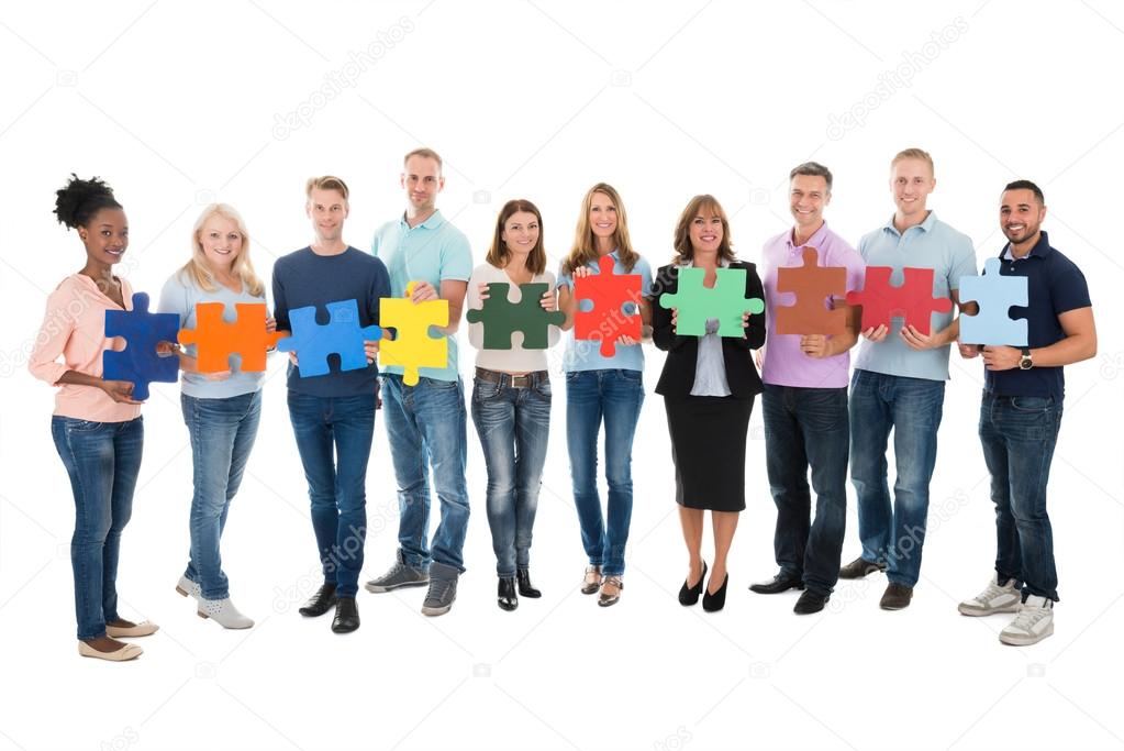 People Holding Jigsaw Pieces