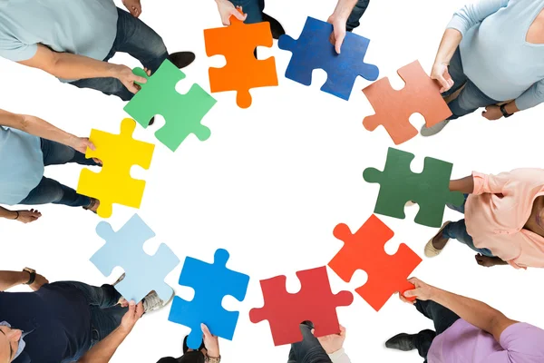 Business Team Holding Jigsaw Pieces — Stock Photo, Image