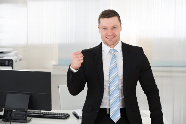 Successful Businessman Clenching Fist In Office — Stock Photo, Image