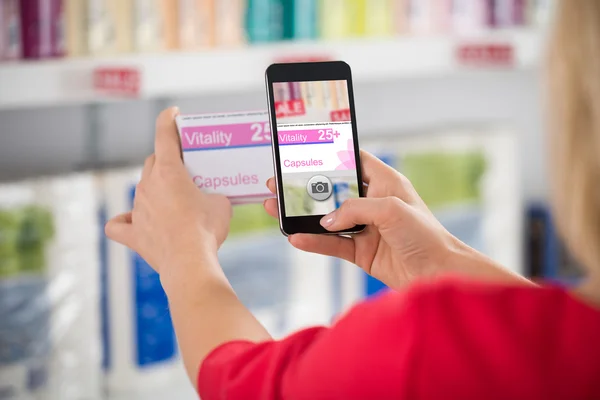 Woman Photographing Capsule Packet In Store — Stock Photo, Image