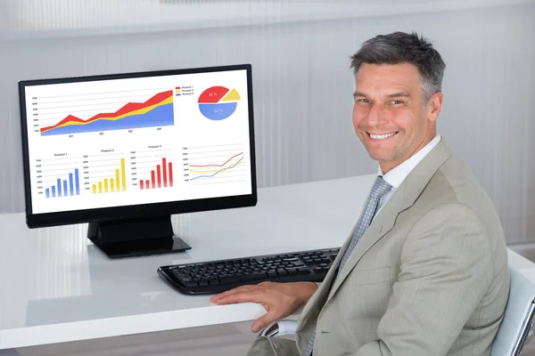 Empresário feliz analisando gráficos financeiros — Fotografia de Stock