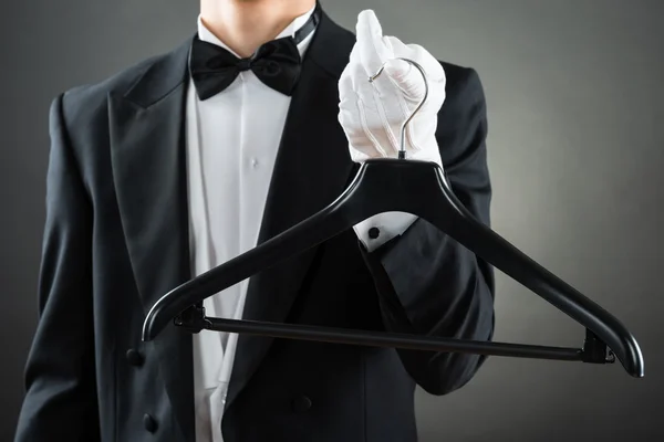 Midsection Of Male Housekeeper Holding Hanger — Stock Photo, Image