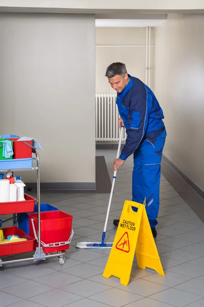 Male Worker With Broom Cleaning Corridor — Stock Photo, Image