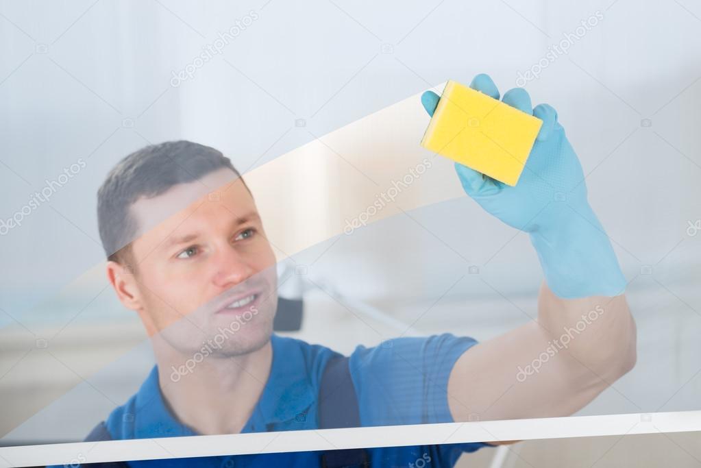 Worker Cleaning Glass With Rag