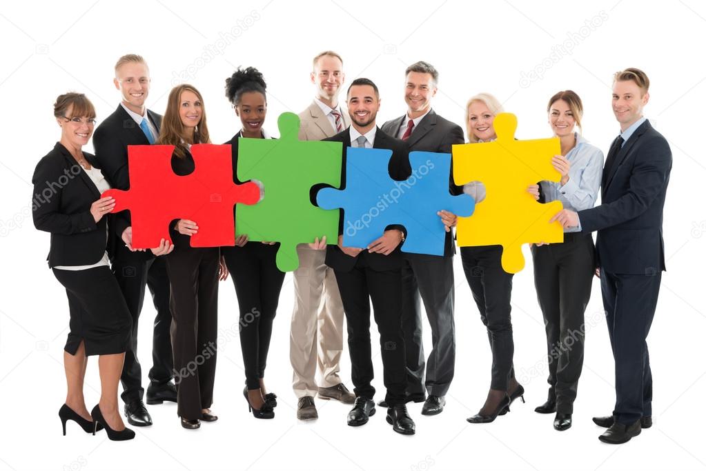 Business Team Holding Jigsaw Pieces