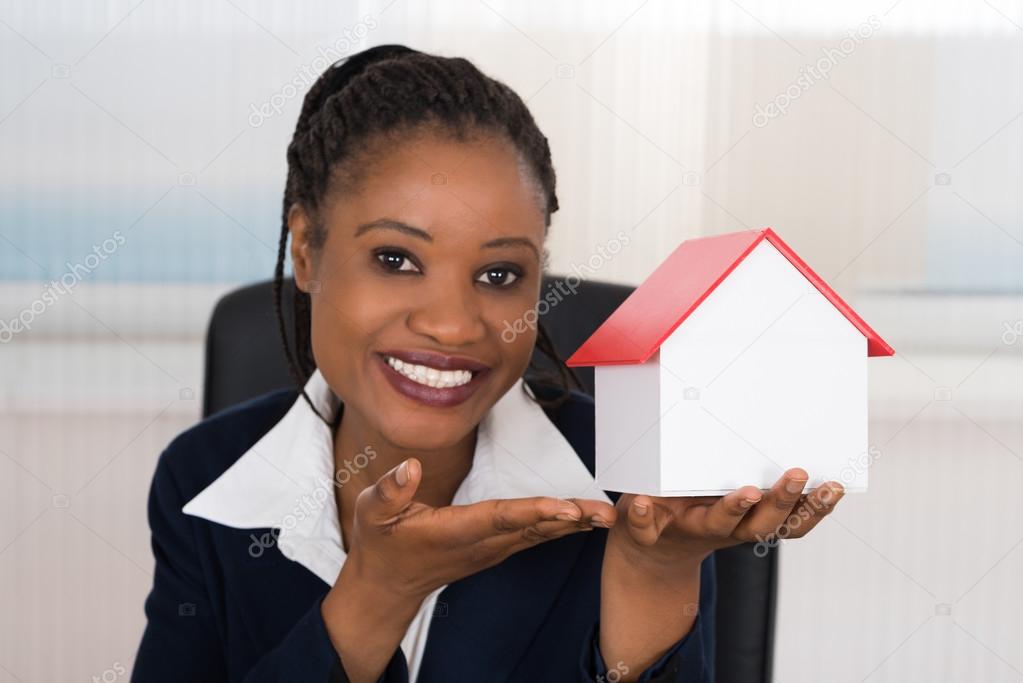 Businesswoman Presenting A House Model