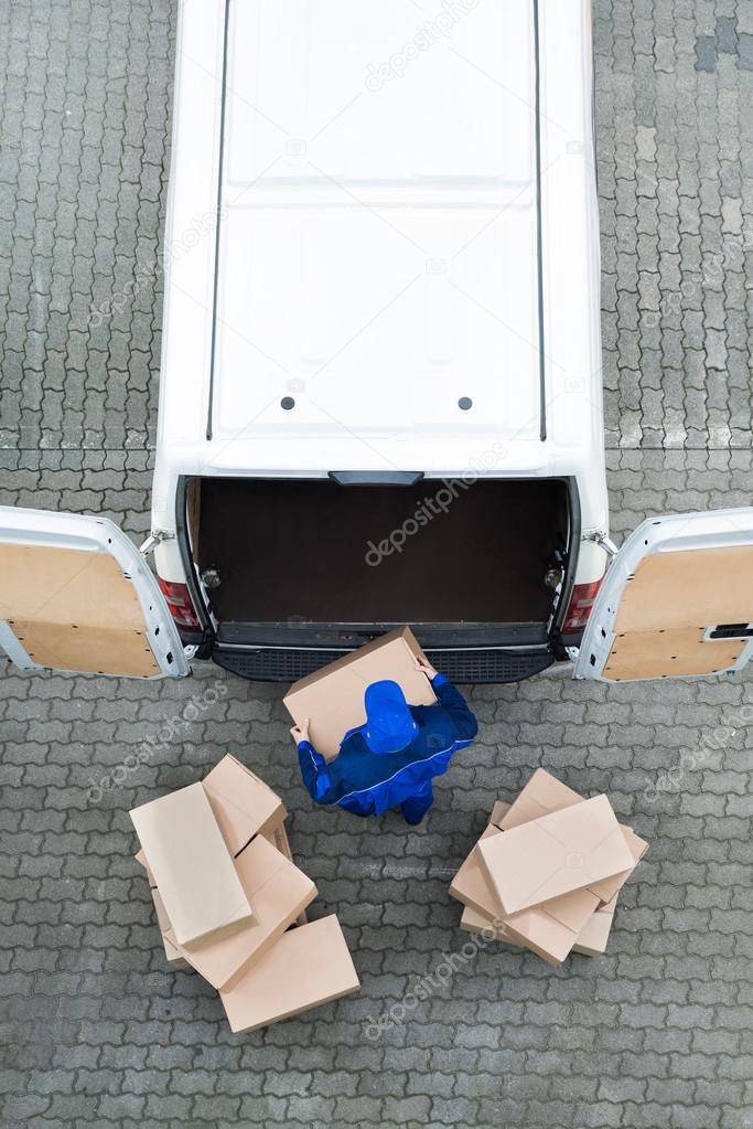 Delivery Man Unloading Cardboard Boxes