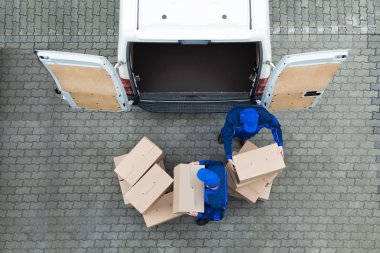 Delivery Men Unloading Cardboard Boxes clipart