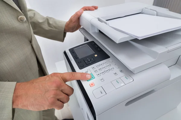 Businessman Pressing Printer's Button — Stock Photo, Image