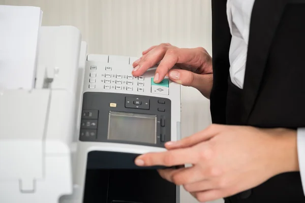 Businesswoman Operating Printer In Office — Stock Photo, Image