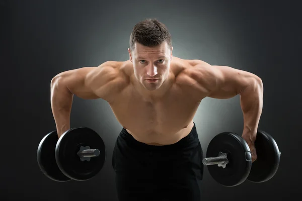 Determined Muscular Man Lifting Dumbbells — Stock Photo, Image