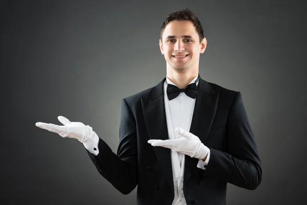 Confident Waiter Presenting Invisible Product — Stock Photo, Image