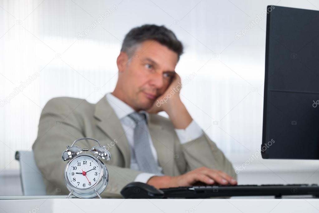 Businessman Using Computer At Desk