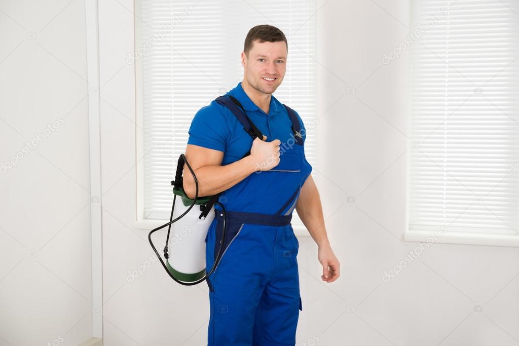 Confident Male Worker Carrying Pesticide Container