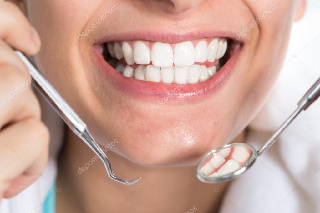 Woman Holding Dental Tools