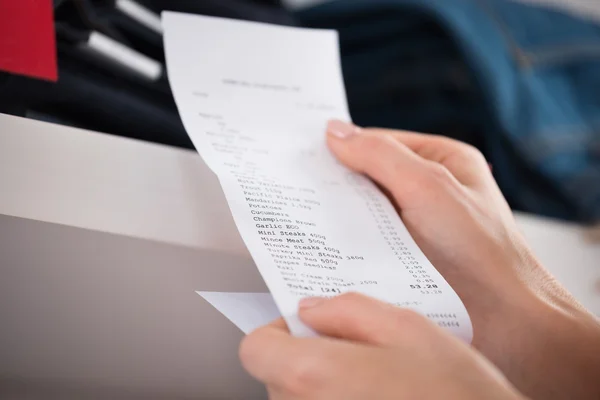 Woman Holding Receipt In Store — Stock Photo, Image