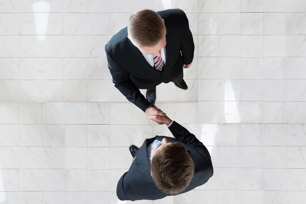 Businessmen Shaking Hands In Office — Stock Photo, Image