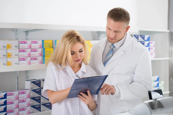 Pharmacists Maintaining Checklist In Pharmacy — Stock Photo, Image