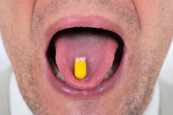 Man With Medicine On Tongue — Stock Photo, Image