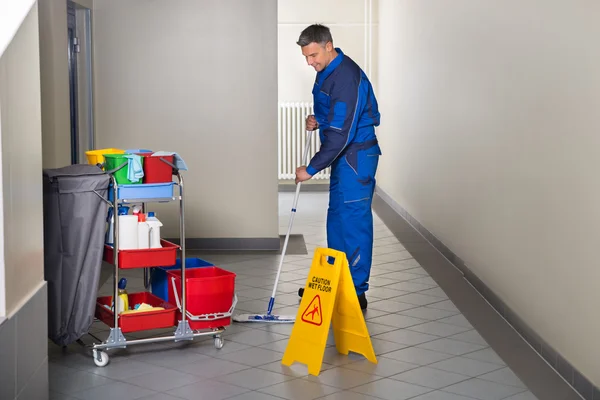 Male Worker With Broom Cleaning Corridor — Stock Photo, Image