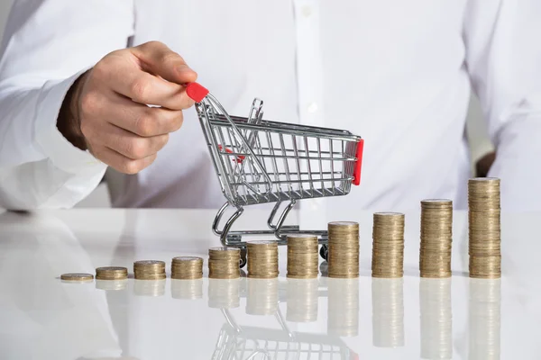 Empresário segurando carrinho de compras — Fotografia de Stock