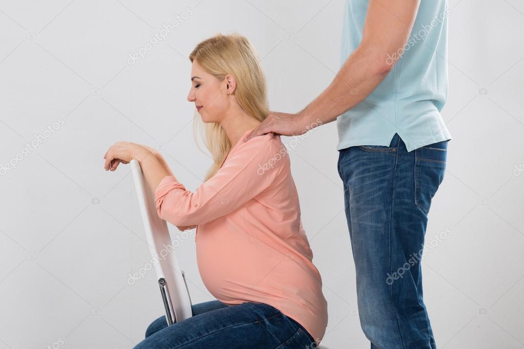 Man giving woman a shoulder massage Stock Photo