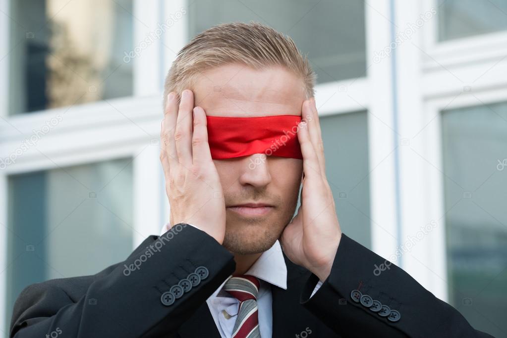 Businessman Touching Red Blindfold